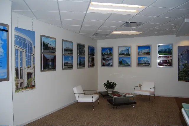 Acrylic printed pictures mounted to brushed silver aluminum with stand offs in a business lobby.