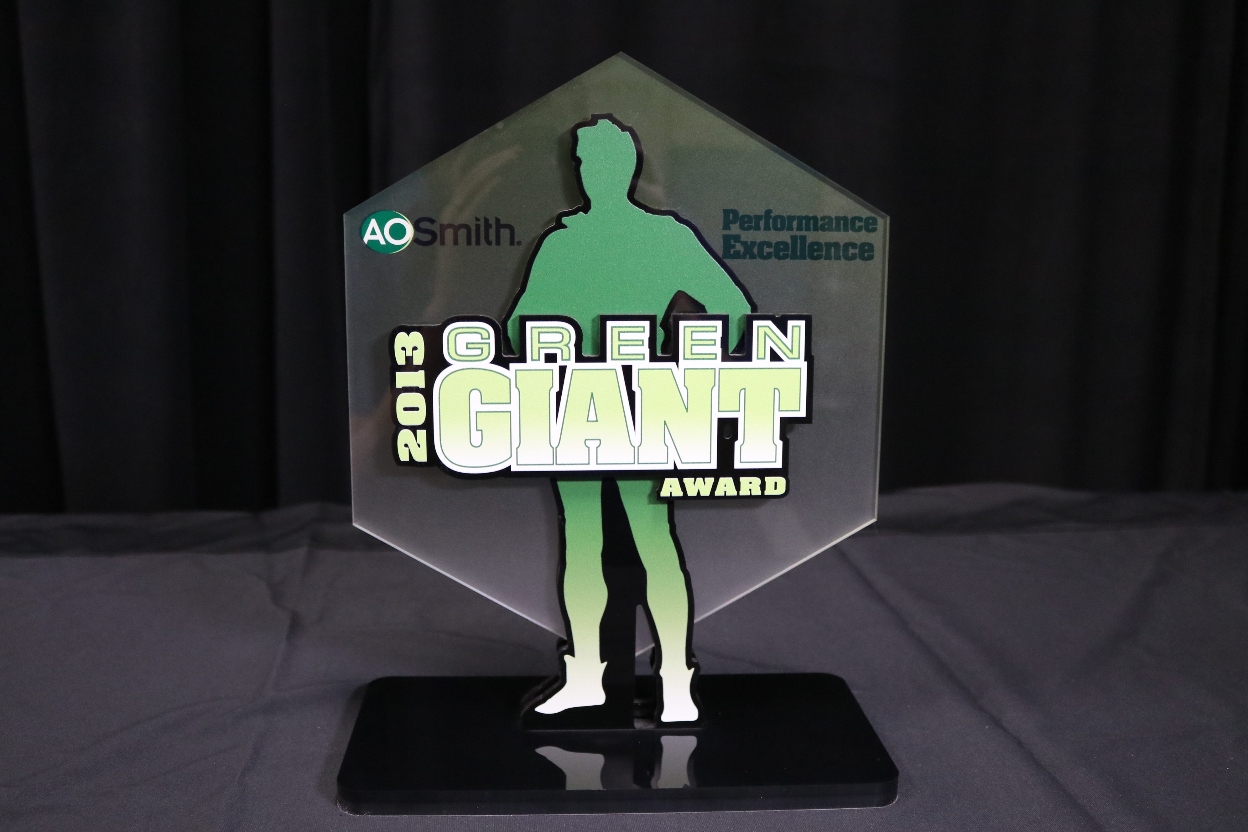 Tabletop award with background printed on frosted acrylic and dimensional front printed on black acrylic.
