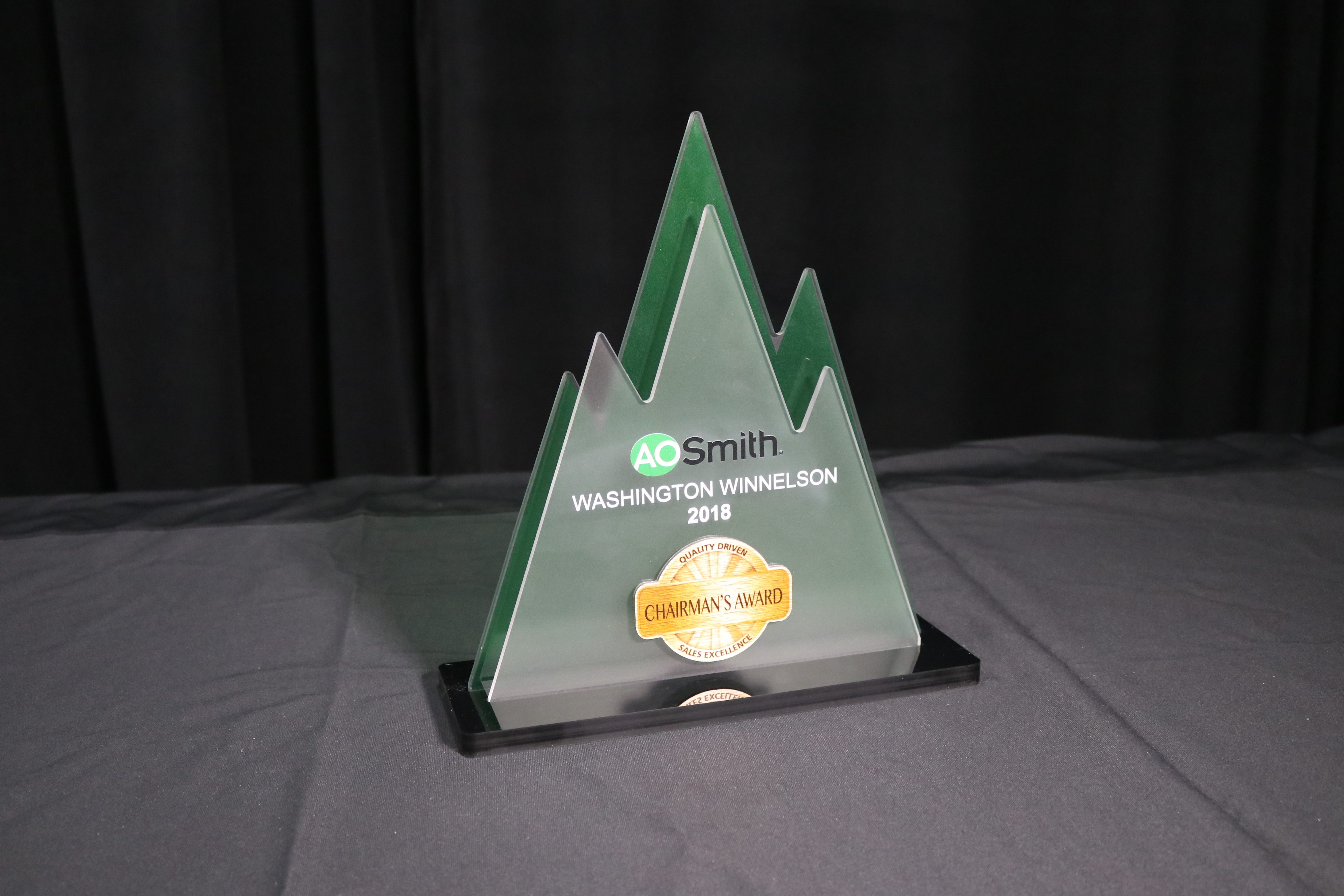 Tabletop award with frosted acrylic shapes inserted into black acrylic base, printed with color and white.