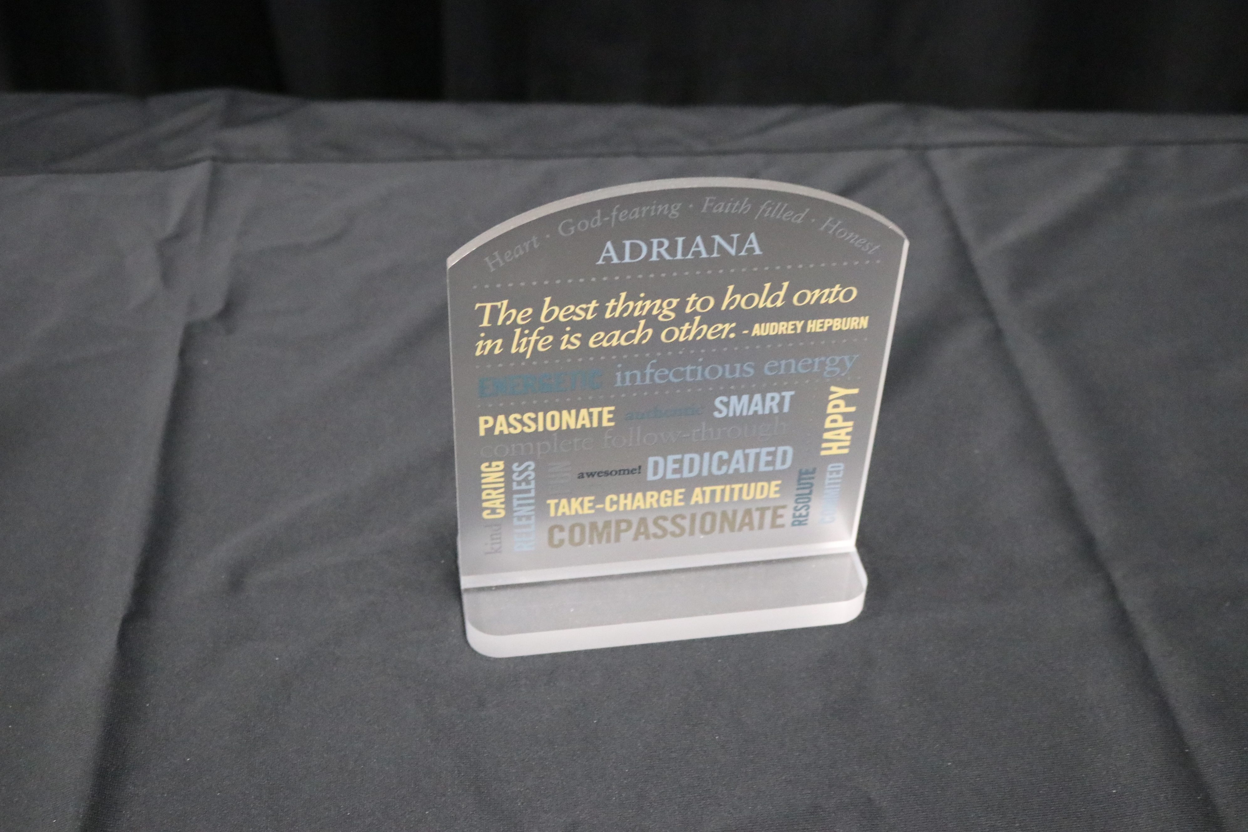 Frosted acrylic Tabletop award for teammate with characteristic words printed on award.