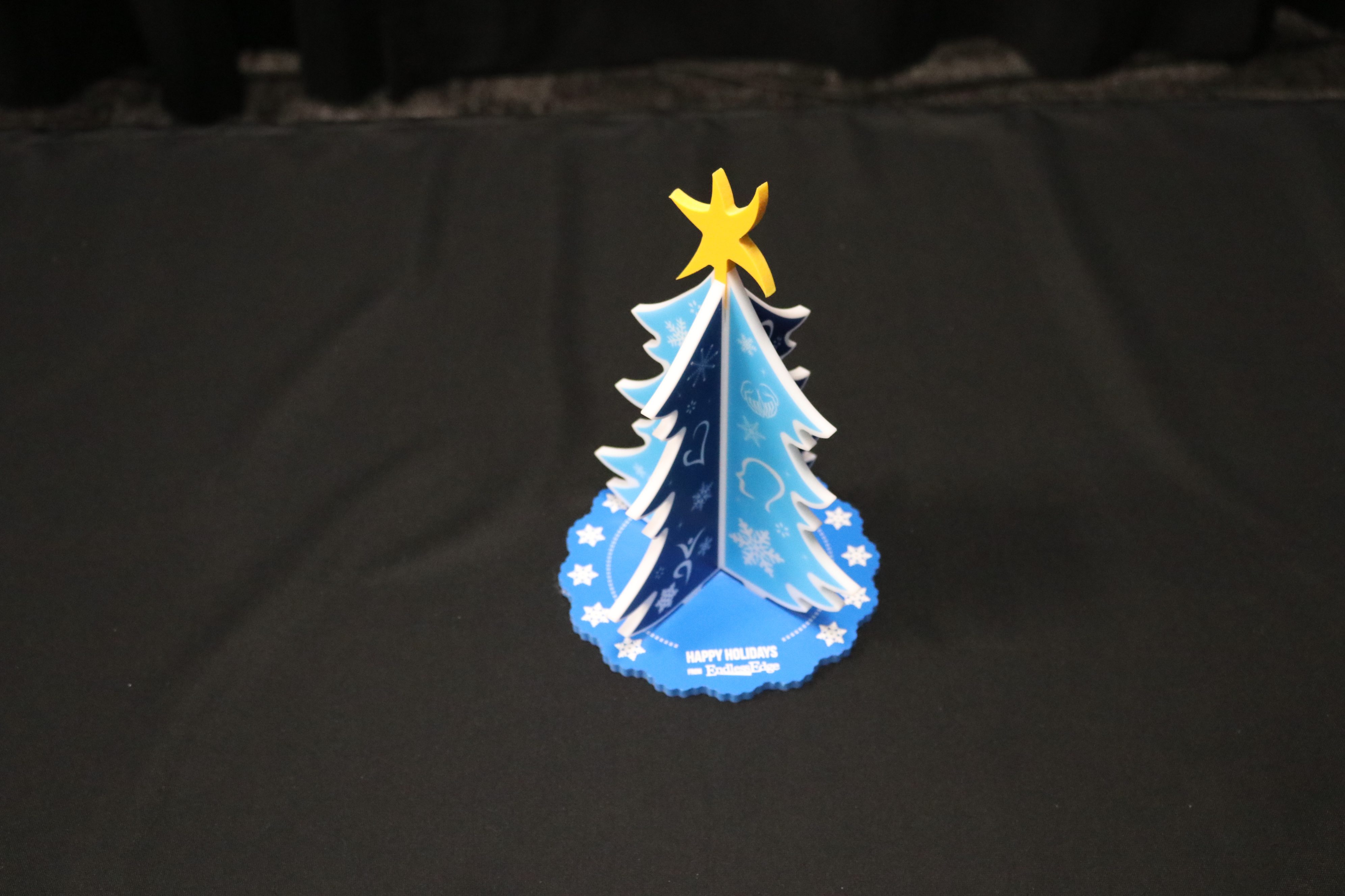 Tabletop display of a Christmas tree printed on white acrylic and colored PVC.