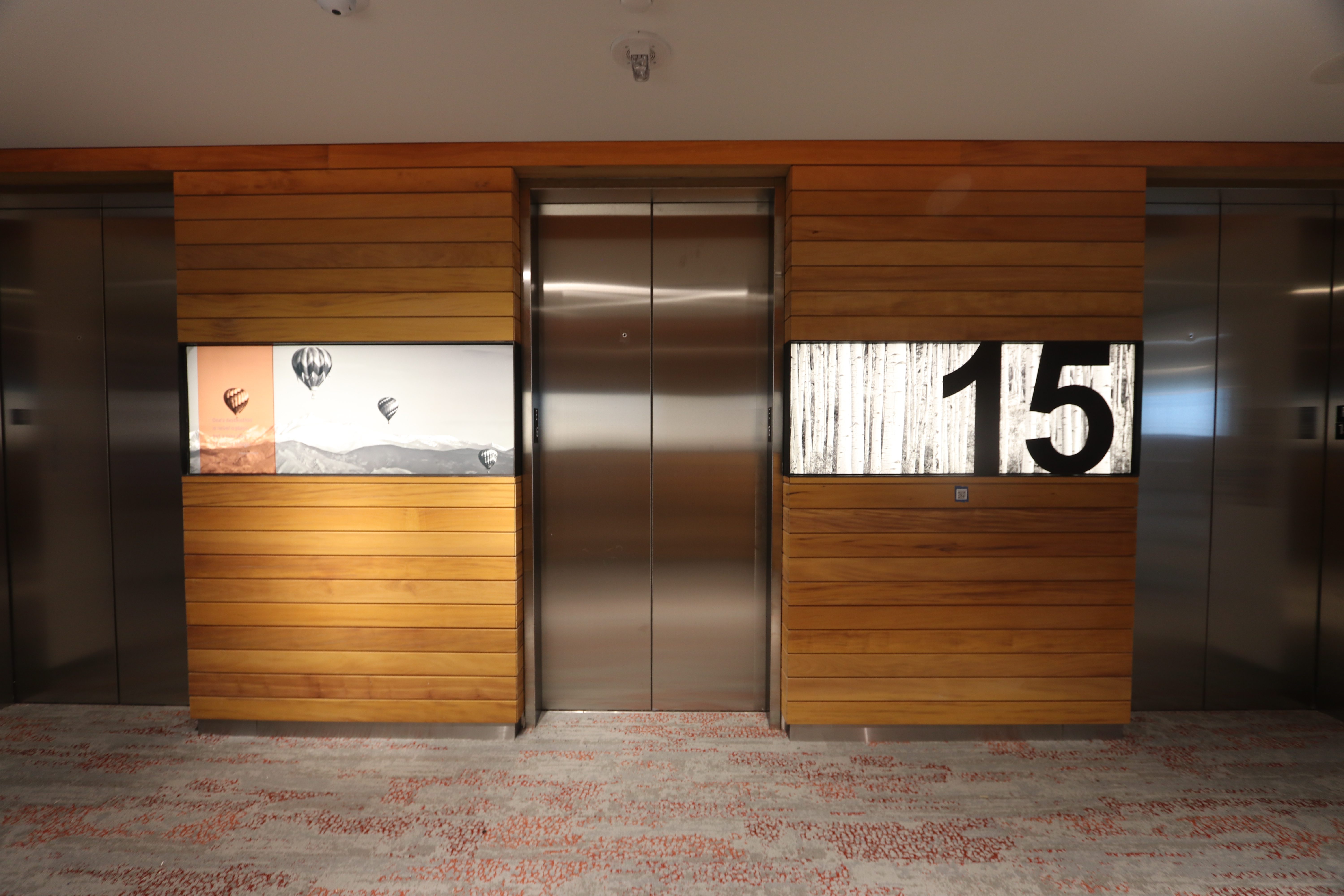 Backlit and translucent acrylic signage in elevator bank.