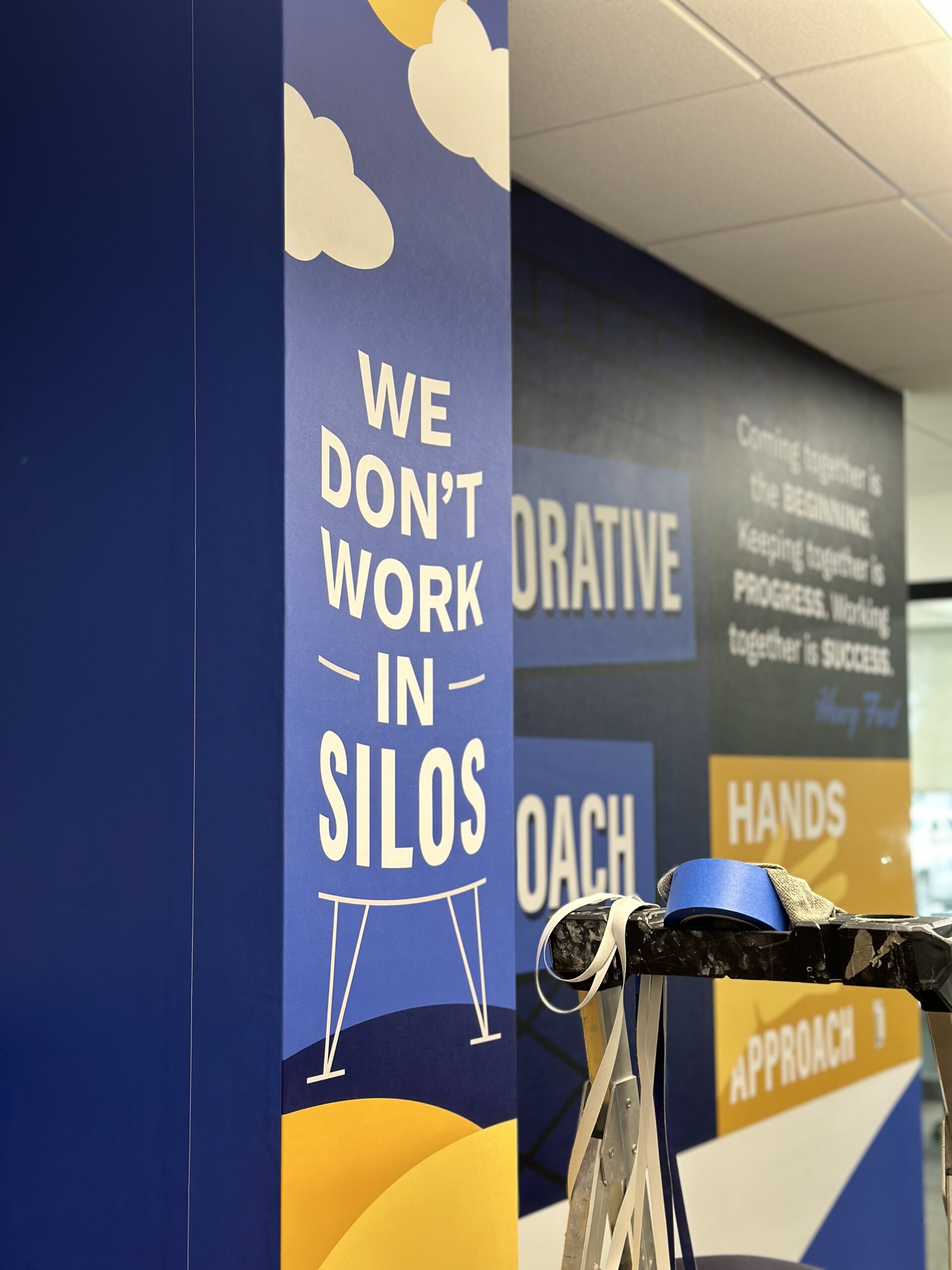 Custom wallpaper with branded motivational quote Custom quote design wallpaper for office in corporate building