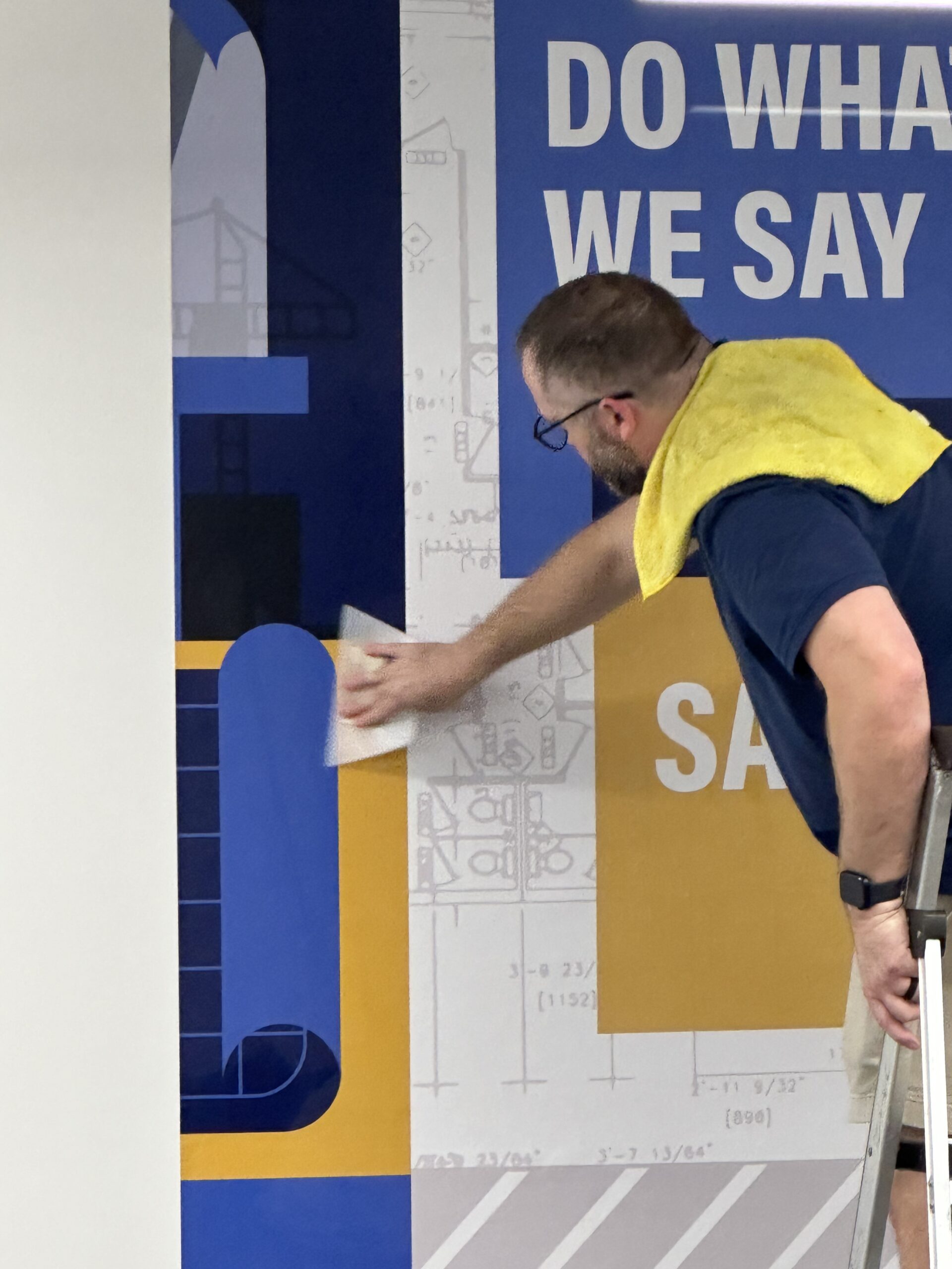 custom wallpaper installation Custom wallpaper being installed on office wall