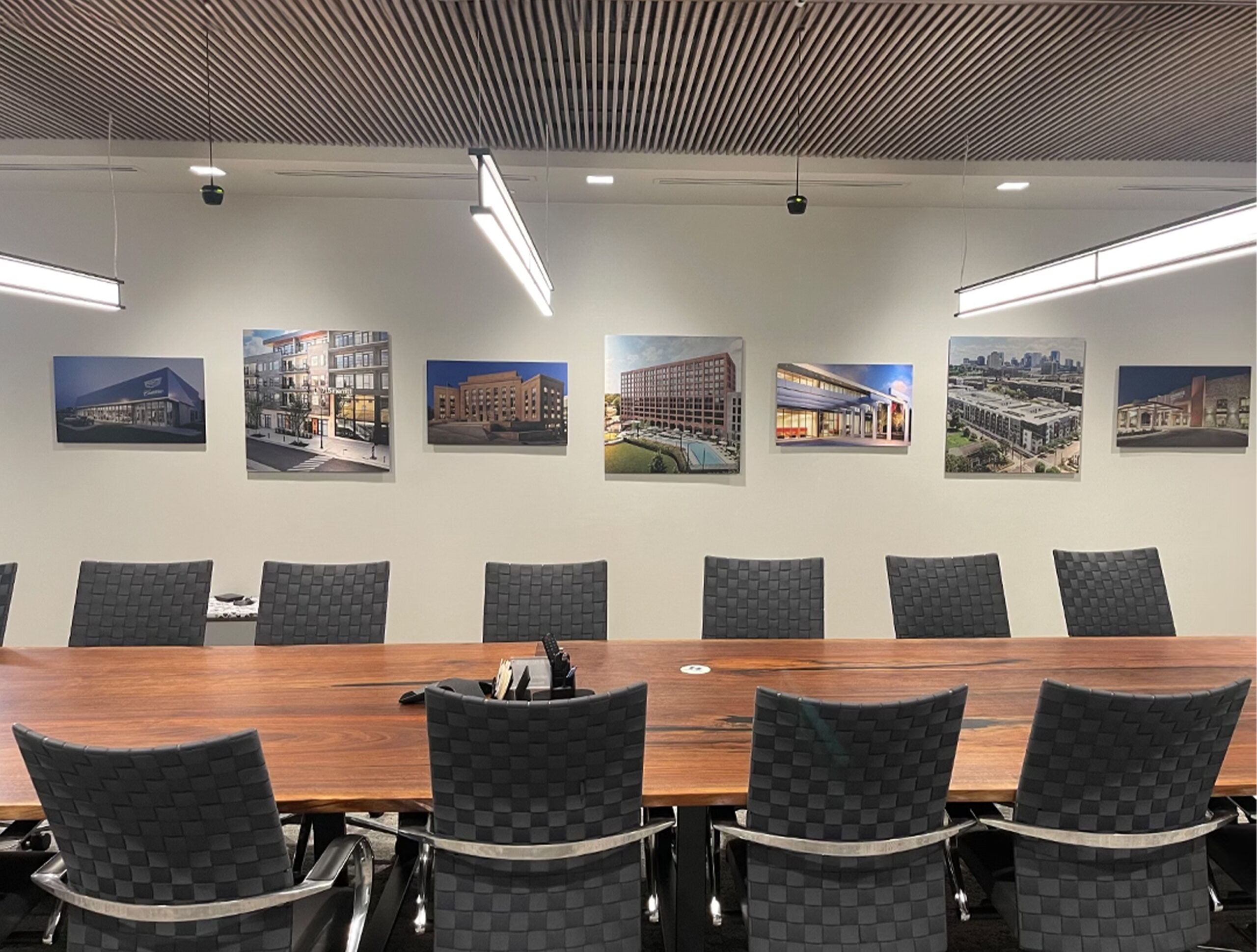 Office conference room wall decor of project highlights Custom photo prints for project highlights in office meeting room