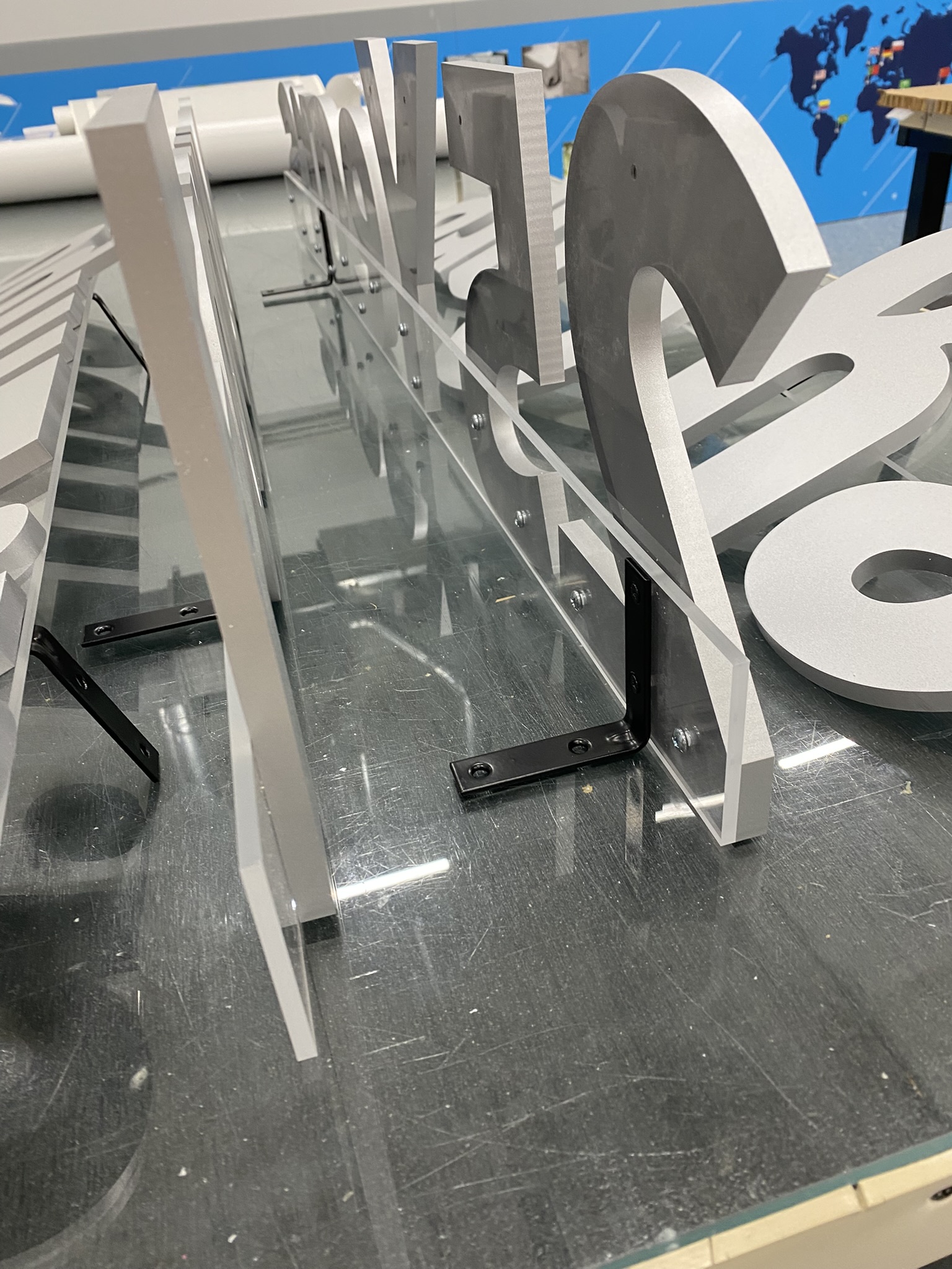 3D Laser cut numbers and letters attached with an l-bracket on a clear acrylic board L-bracket 3D Letters and Numbers attached to a clear acrylic backing