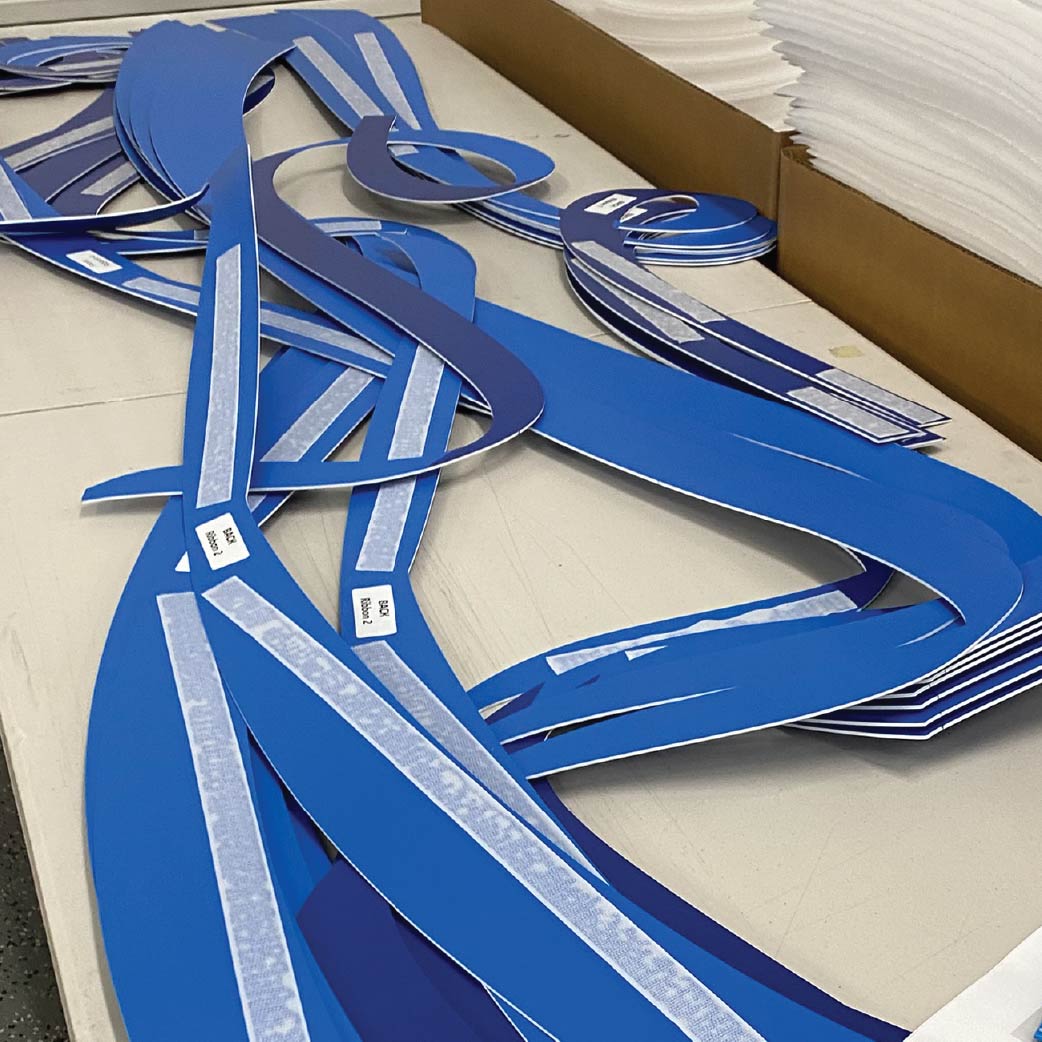 custom ribbons for timeline mural display custom ribbons being prepared for installation on timeline mural wall