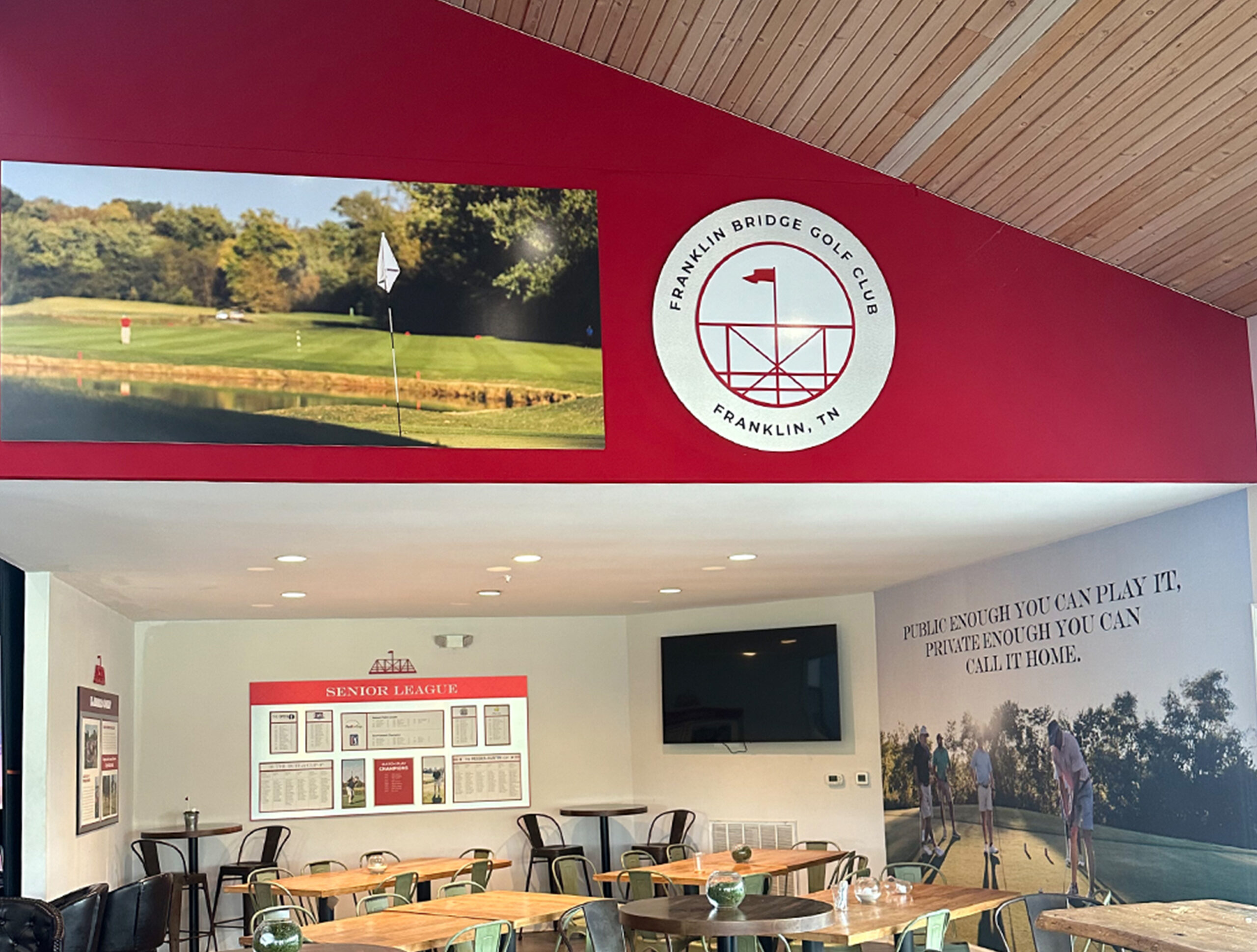 Custom signs for club lounge area Custom logo circle sign and custom photo print on wall with wallpaper in background