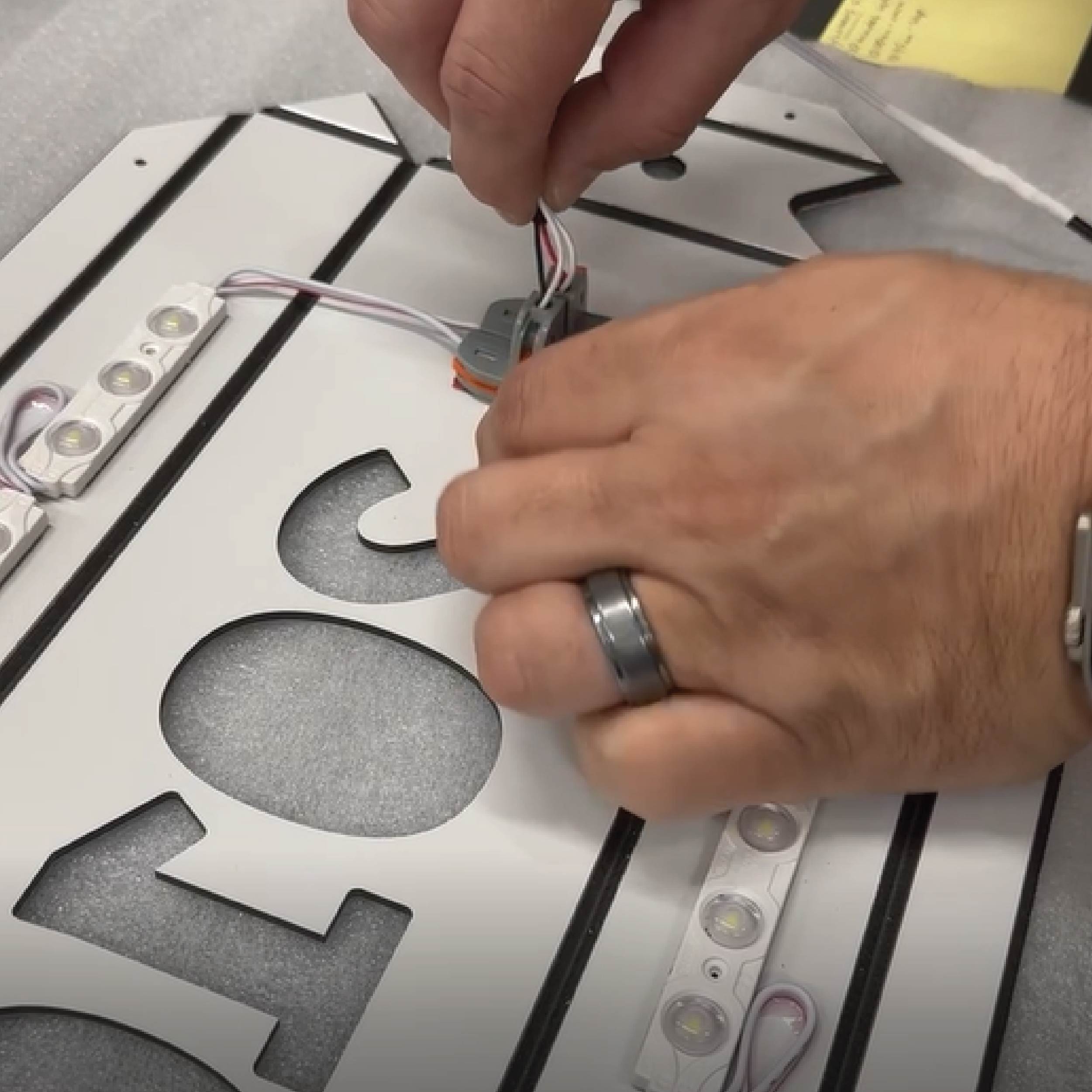 Installing LED Lights in signs Installation of LED lights in timeline mural sign display